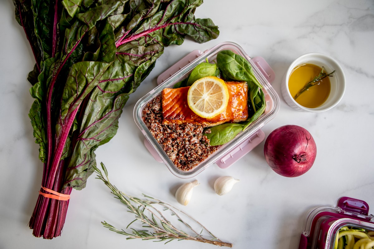 Woman organizing meal prep containers in refrigerator